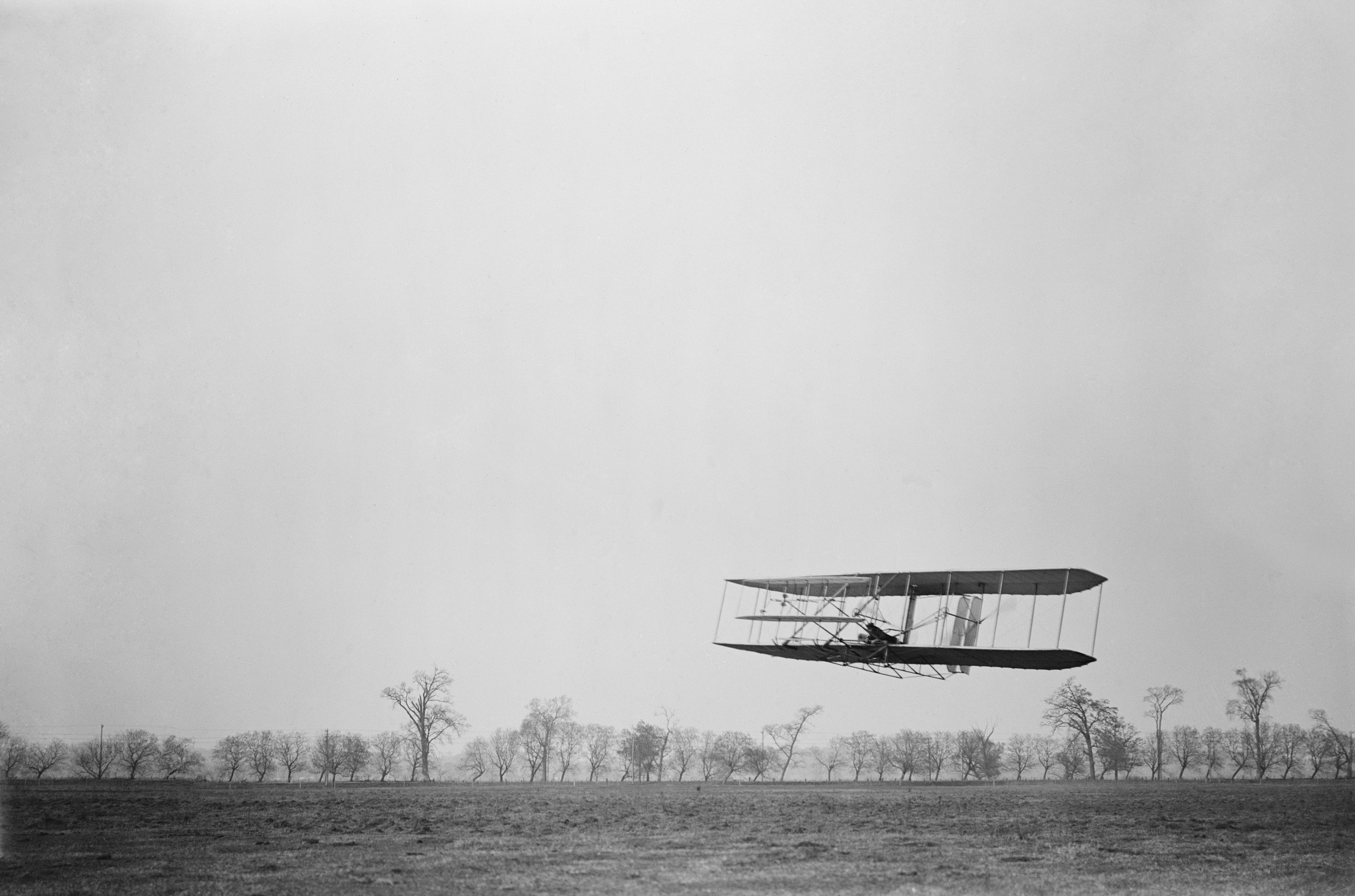 Wright Brothers Conducting Early Aviation Test Flight Historic image of the Wright brothers testing their early aircraft on open field